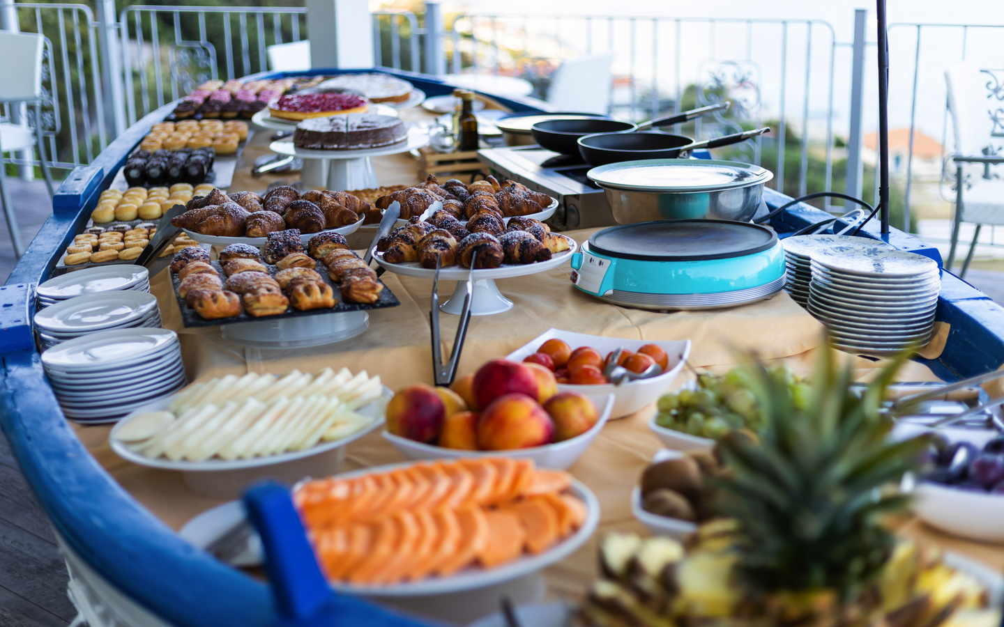 Buffet mit Obst, Gebäck und Pfannen auf einem Tisch bei einem Hotel in Italien.