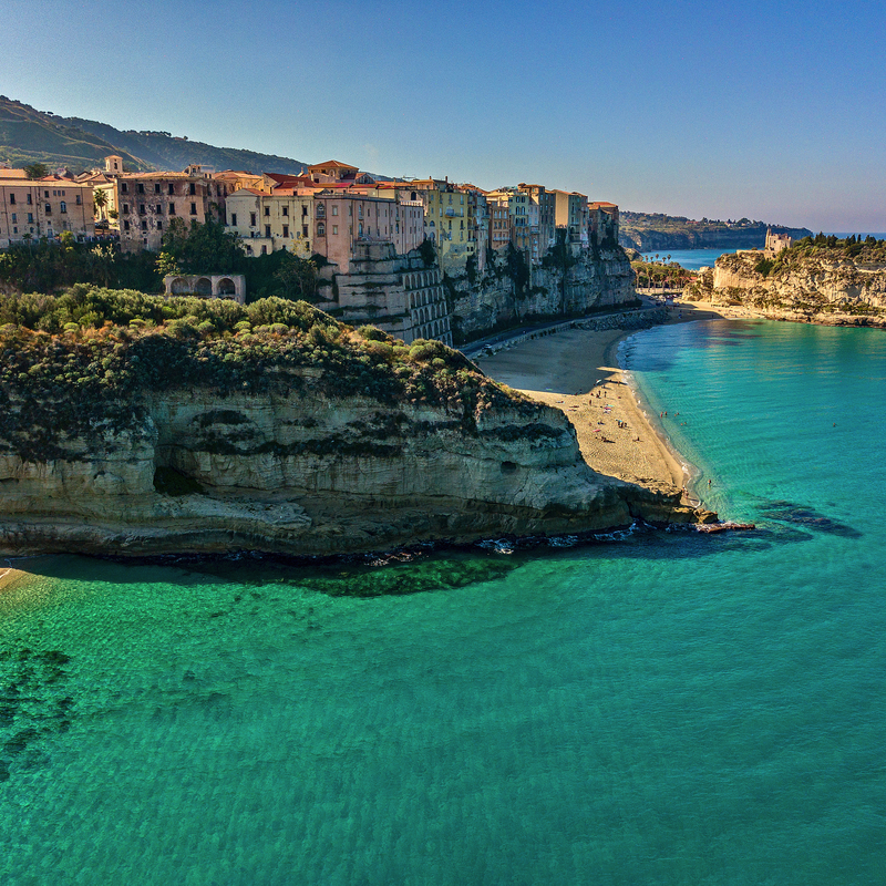 Küstenstadt Tropea in Kalabrien mit türkisfarbenem Meer und Strand.