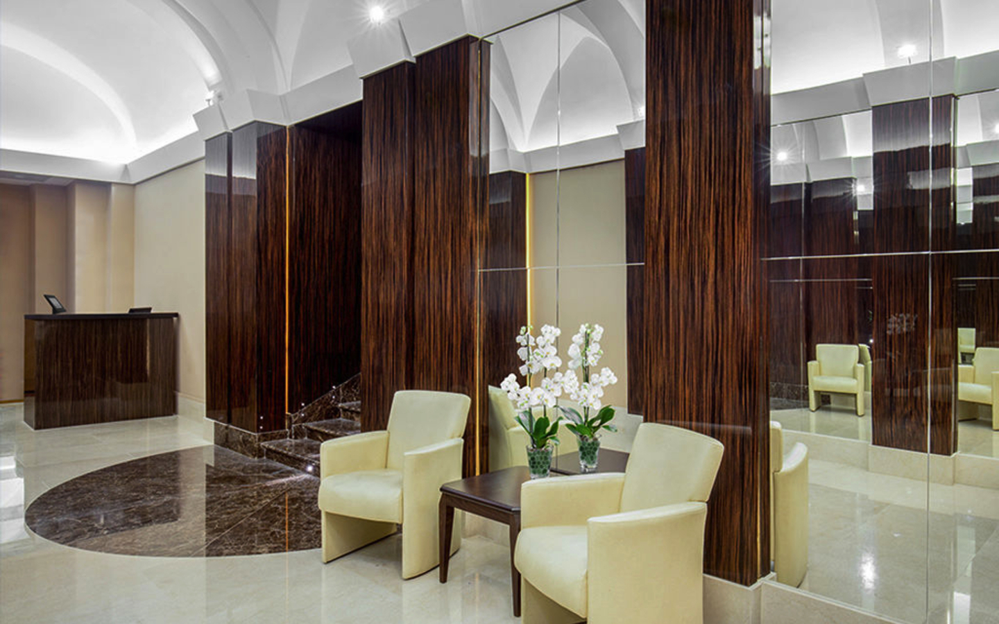 Lobby des Hotel Gioberti in Rom mit Möbeln und Pflanzen.