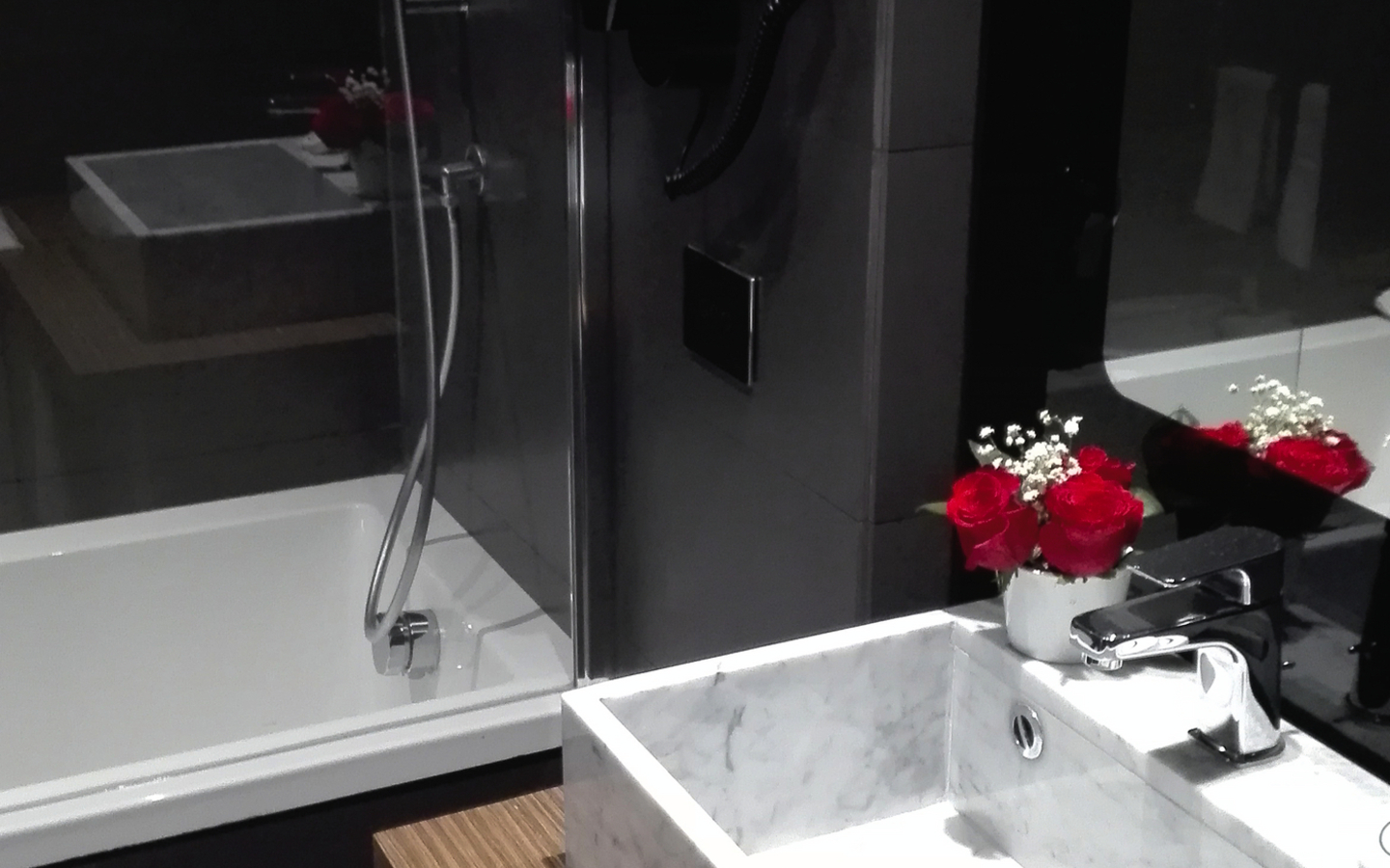 Modernes Badezimmer mit Waschbecken, Spiegel und Badewanne.