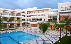 Hotelresort mit Pool, umgeben von Palmen auf Kreta.