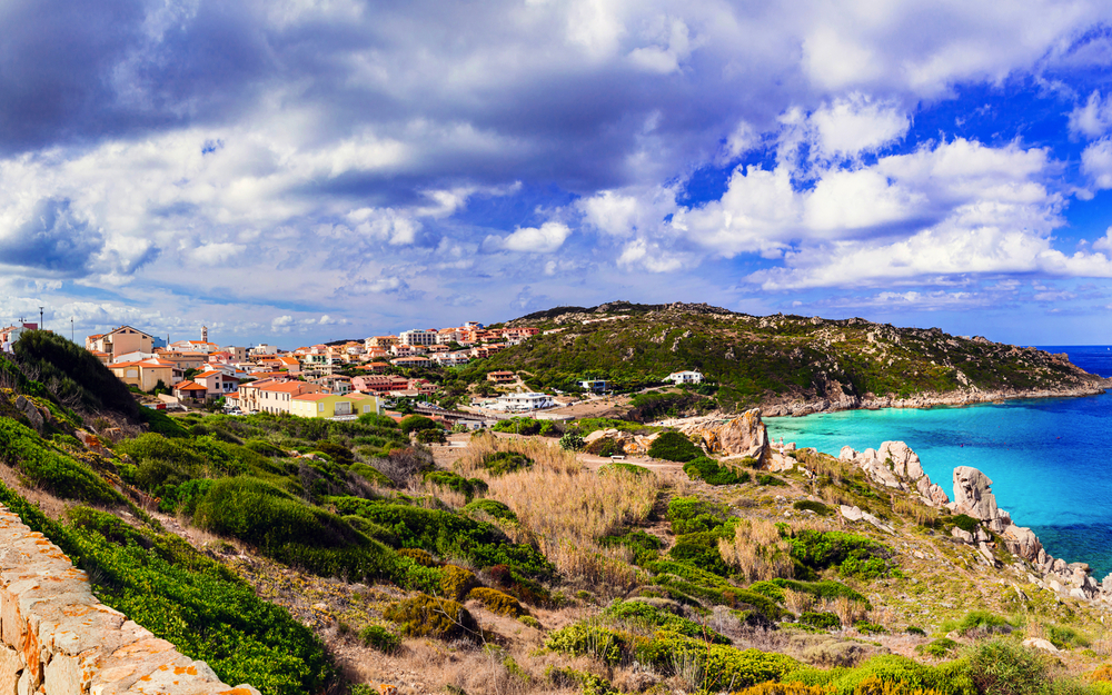 Italy summer holidays. Sardegnia island . village Santa Teresa di Galura in northern part with turquoise sea and defencive old tower 