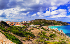Italy summer holidays. Sardegnia island . village Santa Teresa di Galura in northern part with turquoise sea and defencive old tower 