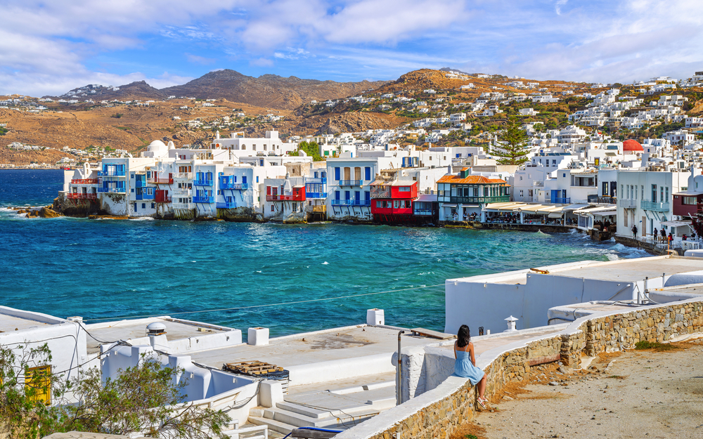 Colorful fisherman houses built at the edge of the sea in the Little Venice district of Mykonos Town, or Chora, on the island of Mykonos, Greece.