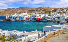 Colorful fisherman houses built at the edge of the sea in the Little Venice district of Mykonos Town, or Chora, on the island of Mykonos, Greece.