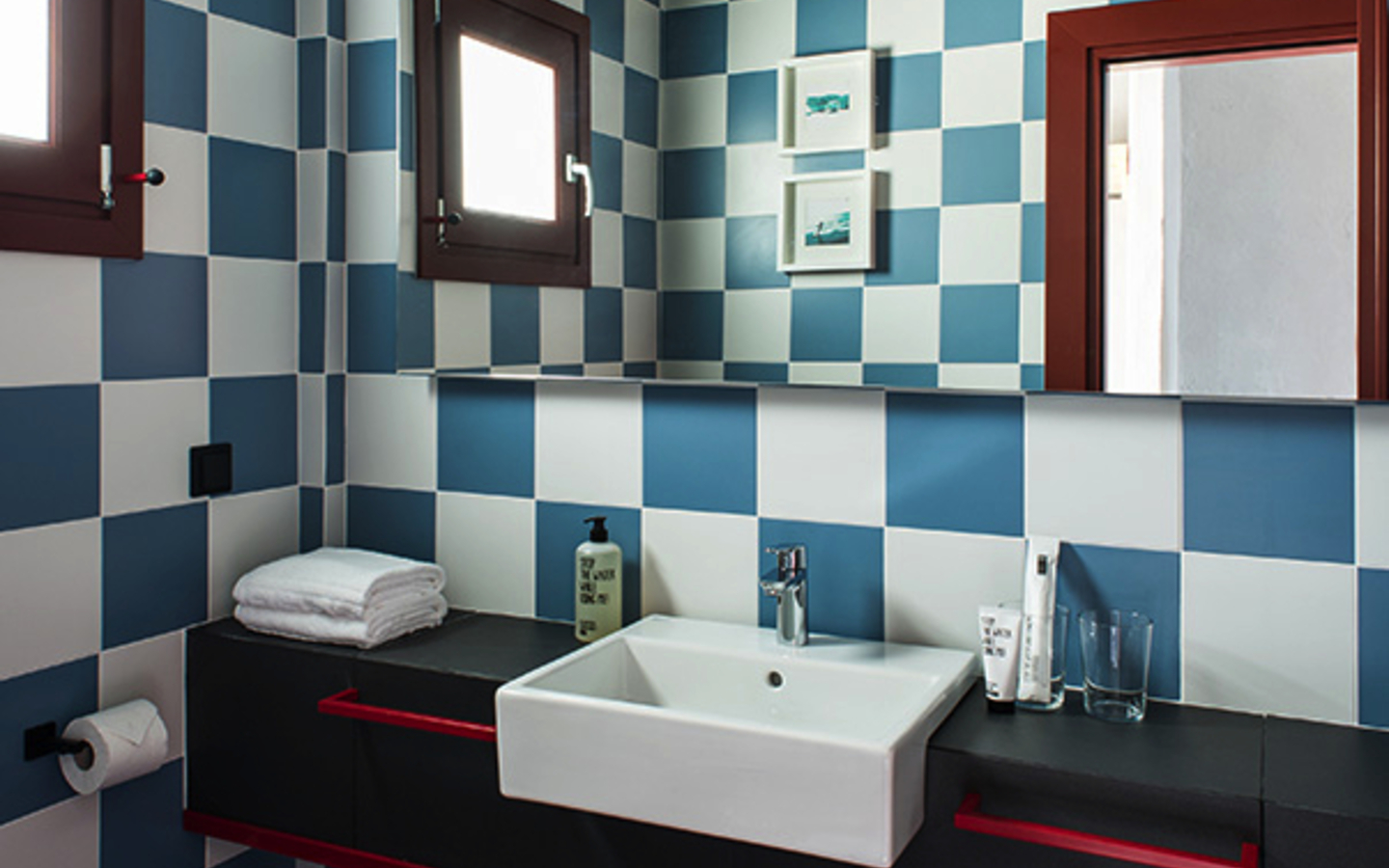 Badezimmer mit blau-weißen Fliesen und modernen Armaturen.