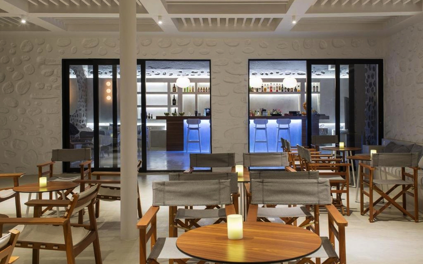 Barbereich mit Holzmöbeln im Alkistis Beach Hotel, Mykonos.