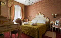 Elegantes Hotelzimmer mit Doppelbett und klassischer Einrichtung.