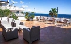 Terrasse mit Sitzmöbeln und Meerblick am Hotel Palazzo Durante in Sizilien.