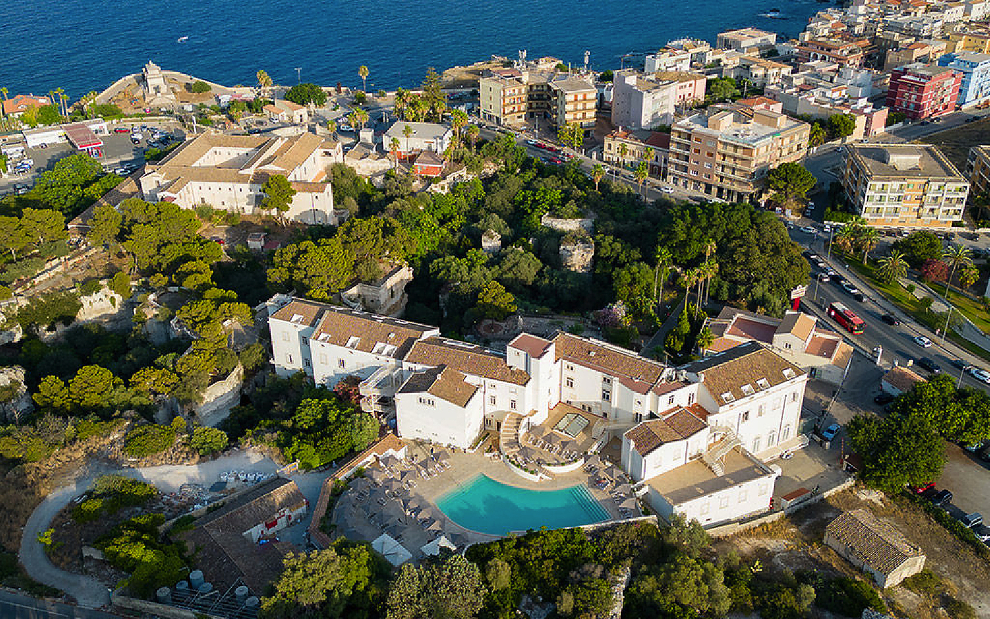 Luftaufnahme des Grand Hotel Villa Politi in Syrakus, umgeben von Bäumen und Gebäuden.